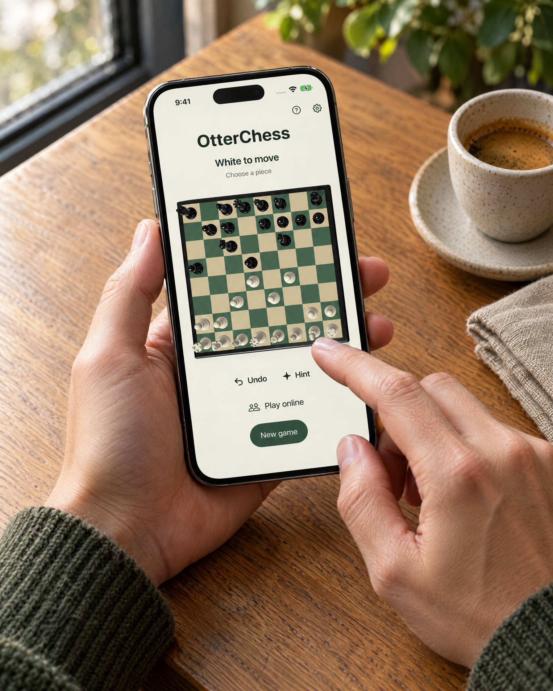 Hands playing OtterChess on iPhone at a café table